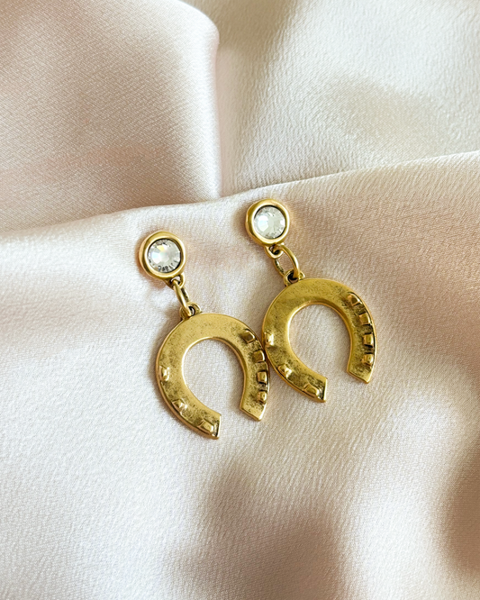 Gold horseshoe earrings with clear stones