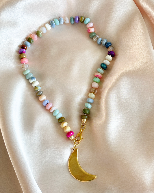 Multicolored beaded necklace with a gold crescent moon pendant